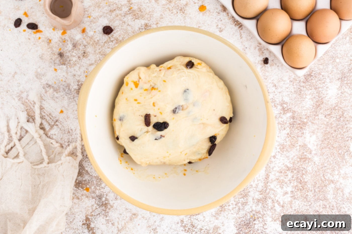 Spiced Easter Buns 12 Raisins and candied orange peels being kneaded into the risen dough.
