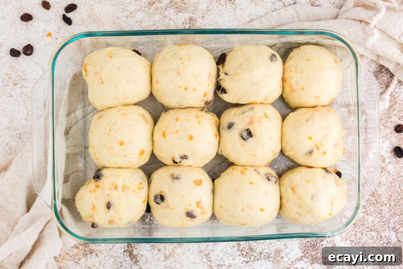 Spiced Easter Buns 15 Dough balls risen significantly and now touching in a baking dish, ready for the oven.