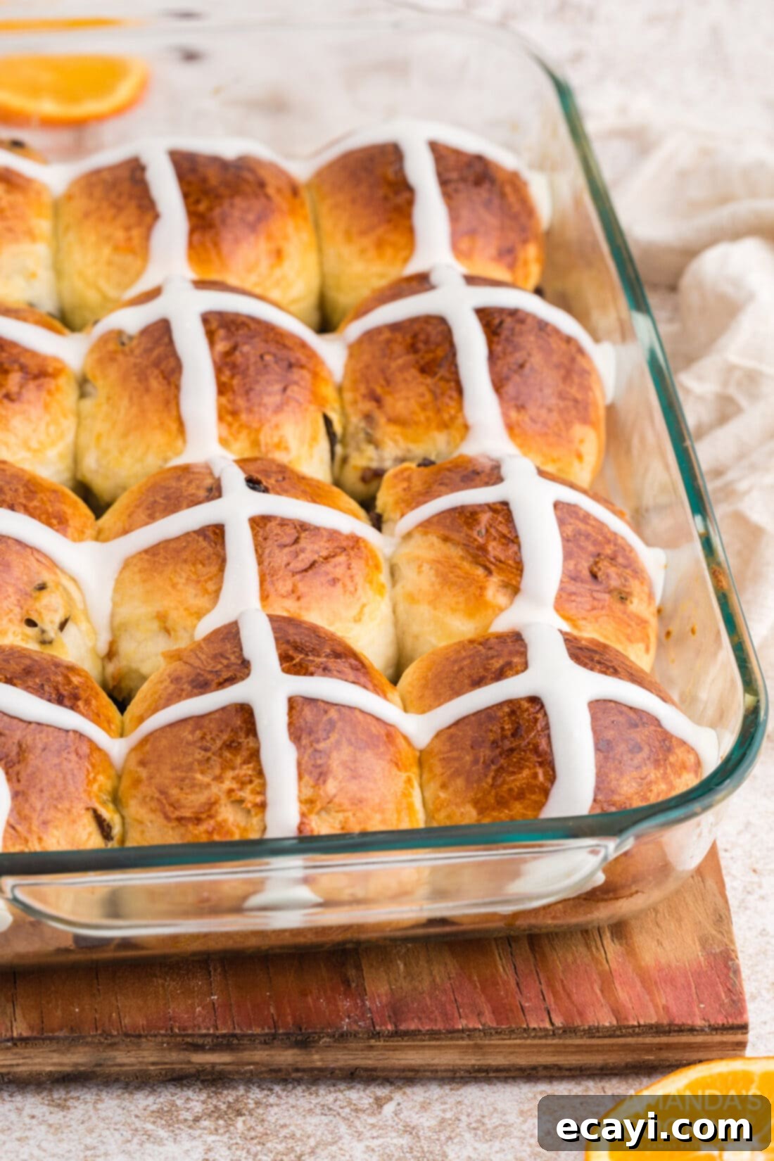 Spiced Easter Buns 19 A glass pan full of baked and iced Hot Cross Buns, beautifully arranged.