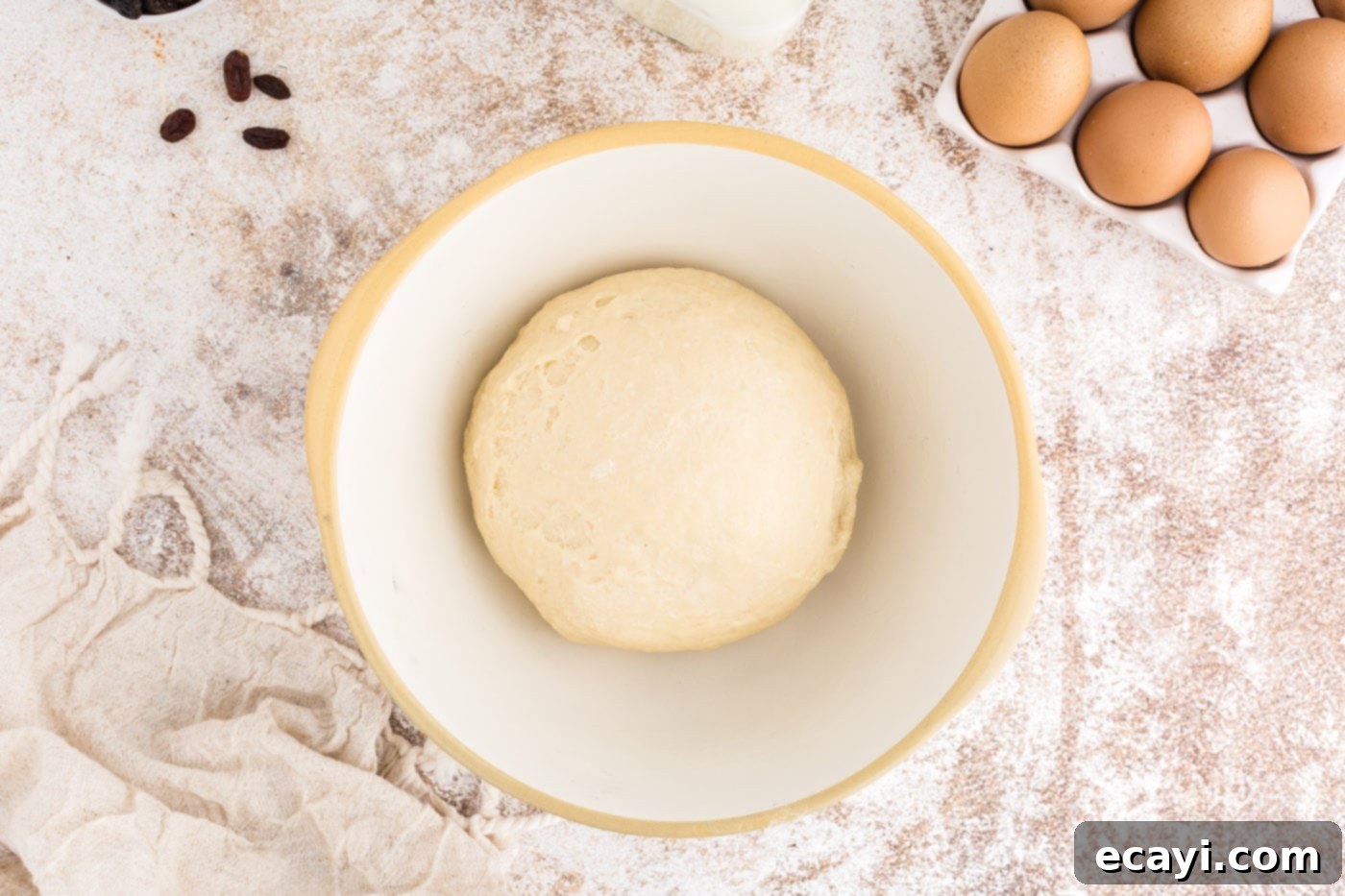 Spiced Easter Buns 10 Smooth dough ball placed in a greased bowl and covered, ready for its first rise.