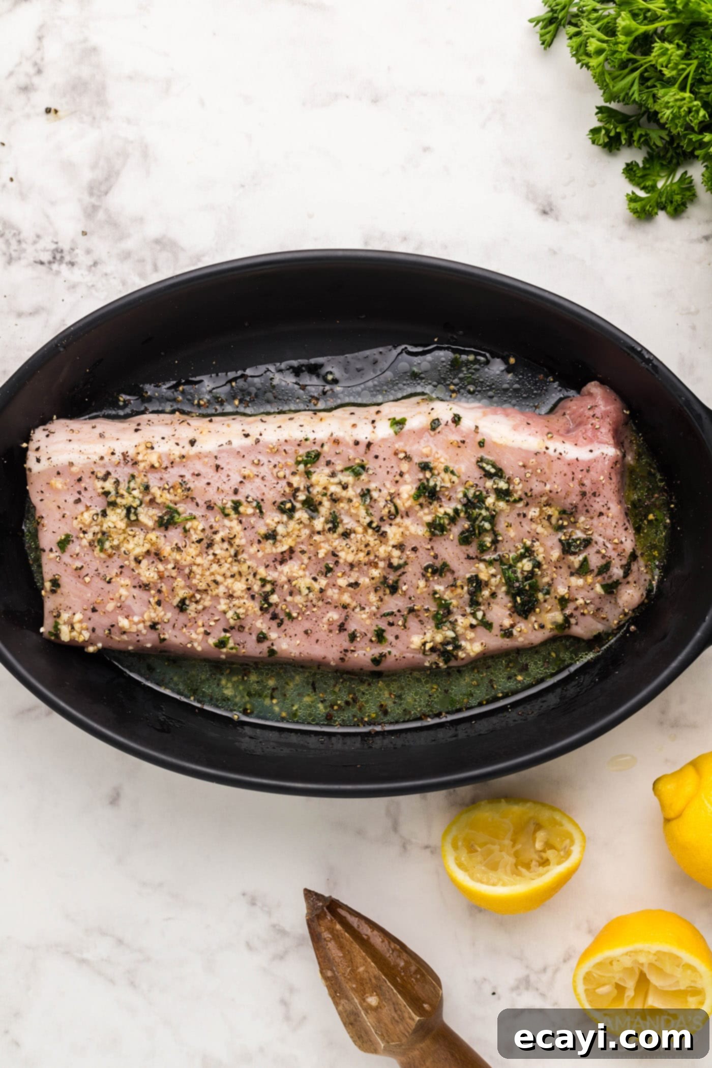 Air Fryer Pork Tenderloin Perfection 6 pork tenderloin marinating in a dish
