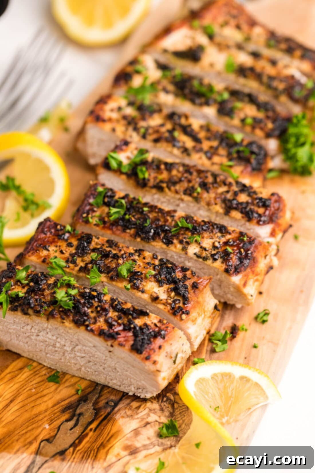 Air Fryer Pork Tenderloin Perfection 9 sliced Air Fryer Pork Tenderloin on a cutting board