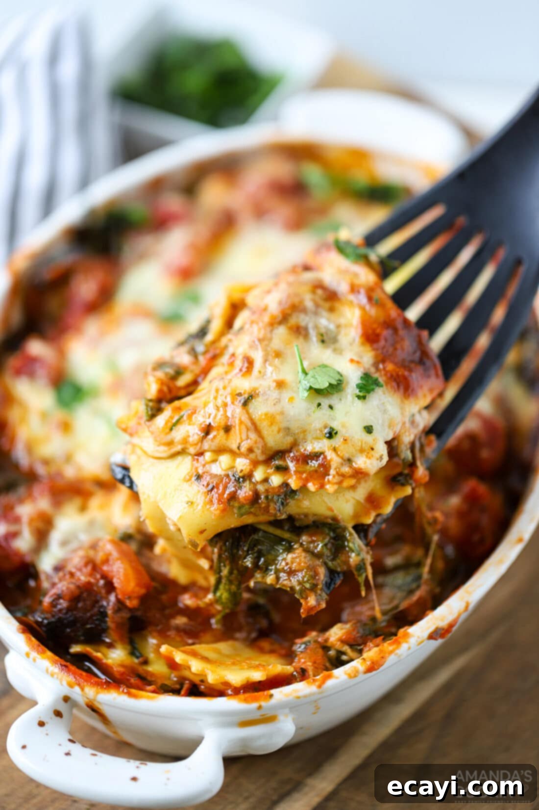 Ravioli Lasagna Casserole 2 A delicious ravioli lasagna casserole with layers of marinara, cheese ravioli, mozzarella, baby spinach, and Italian chicken sausage, baked to a bubbly golden brown perfection.