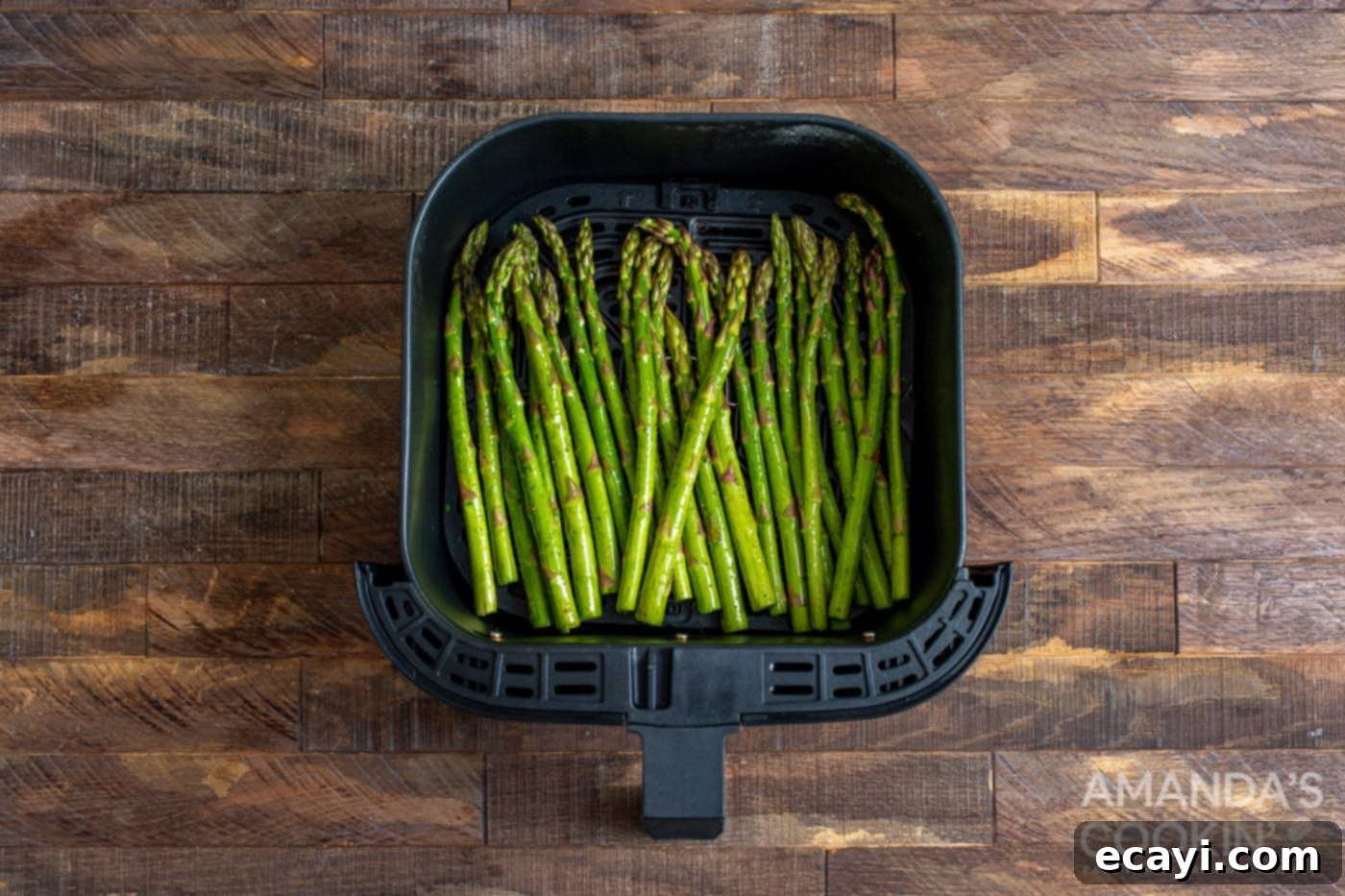 Crispy Air-Fried Asparagus 6 seasoned asparagus spears arranged in a single layer in an air fryer basket