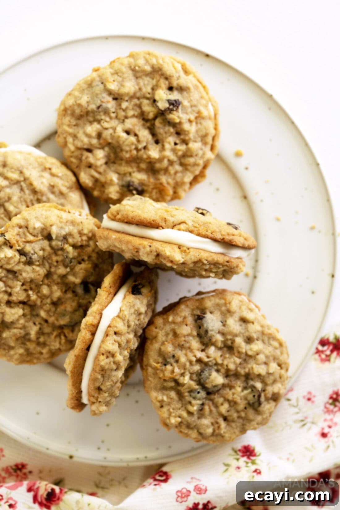 Decadent Carrot Cake Cookie Sandwiches 2 Carrot Cake Sandwich Cookies on a plate
