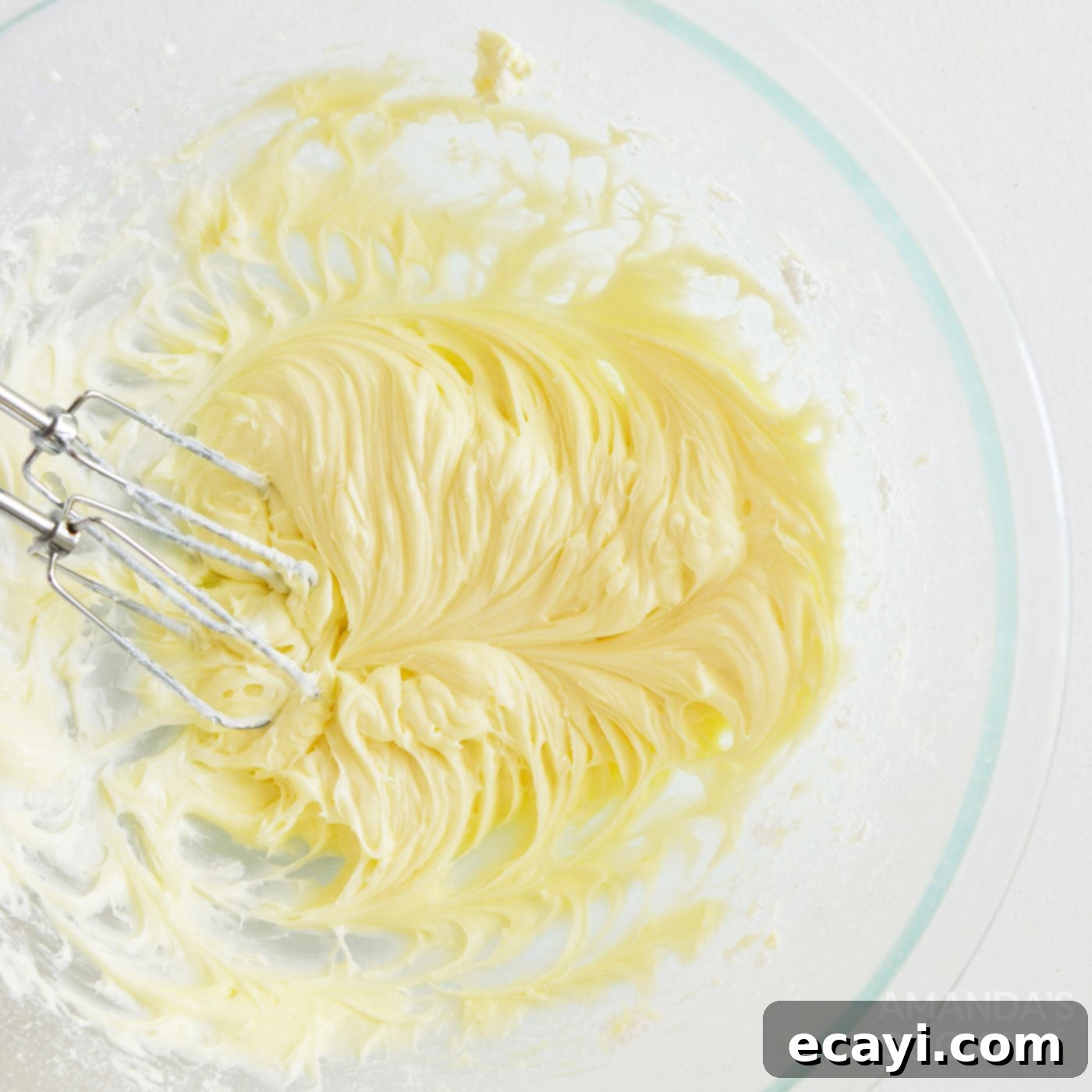 Decadent Carrot Cake Cookie Sandwiches 11 beating cream cheese frosting with a handheld mixer