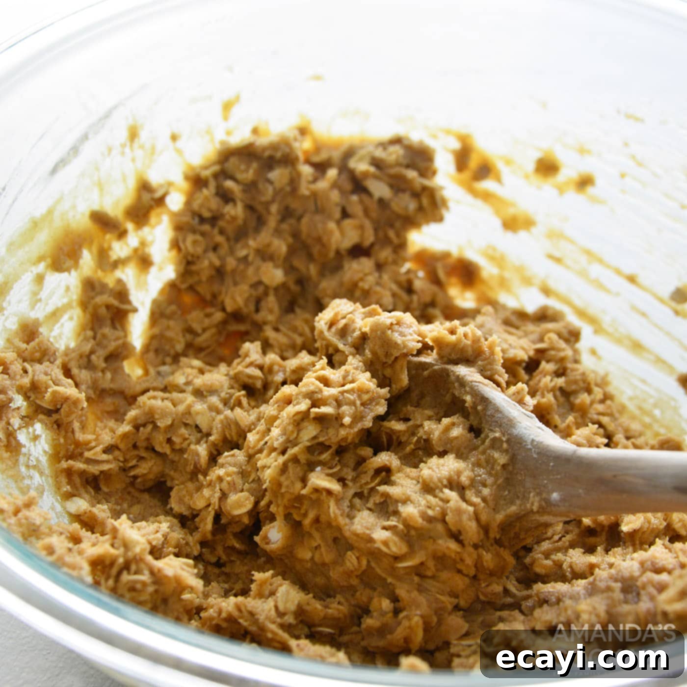 Decadent Carrot Cake Cookie Sandwiches 7 mixing cookie dough with a wooden spoon