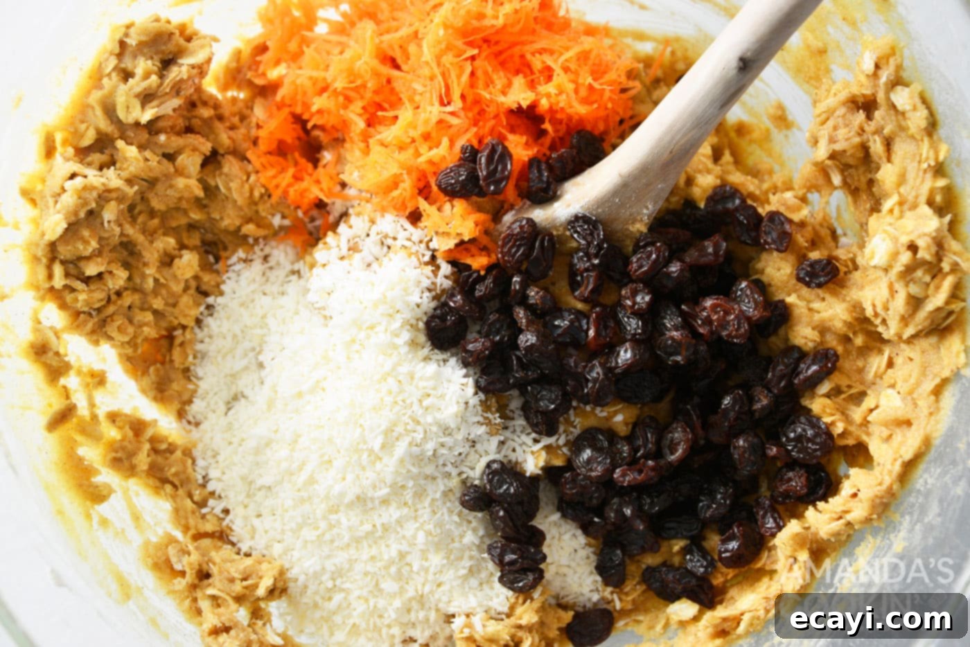 Decadent Carrot Cake Cookie Sandwiches 8 stiring in carrots, shredded coconut, and raisins to a bowl of cookie dough