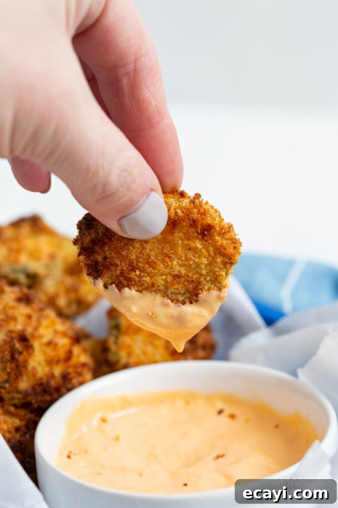 Crispy Air-Fried Pickles 2 dipping an air fryer fried pickle in sauce