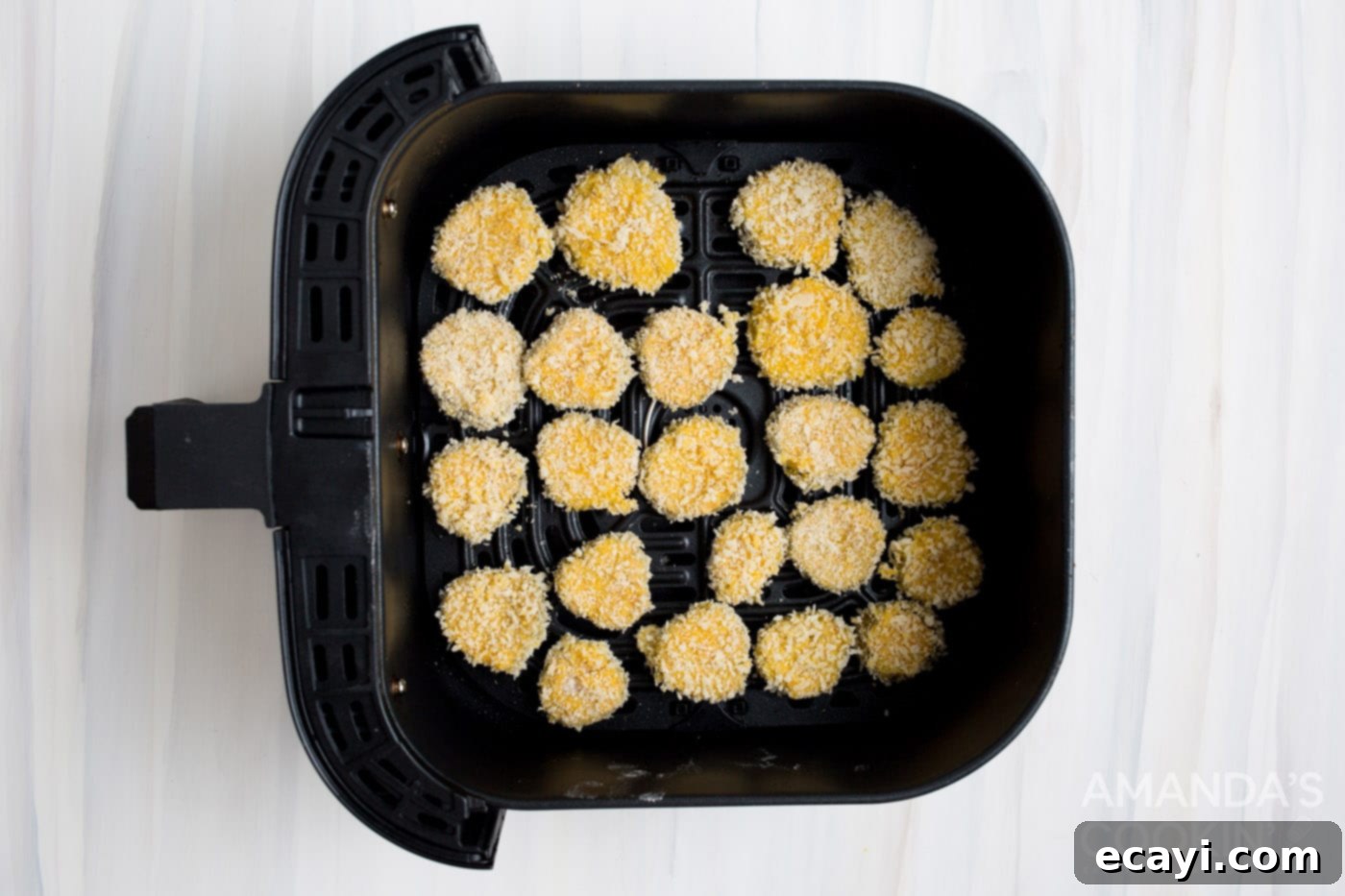 Crispy Air-Fried Pickles 6 panko coated pickle chips in an air fryer basket