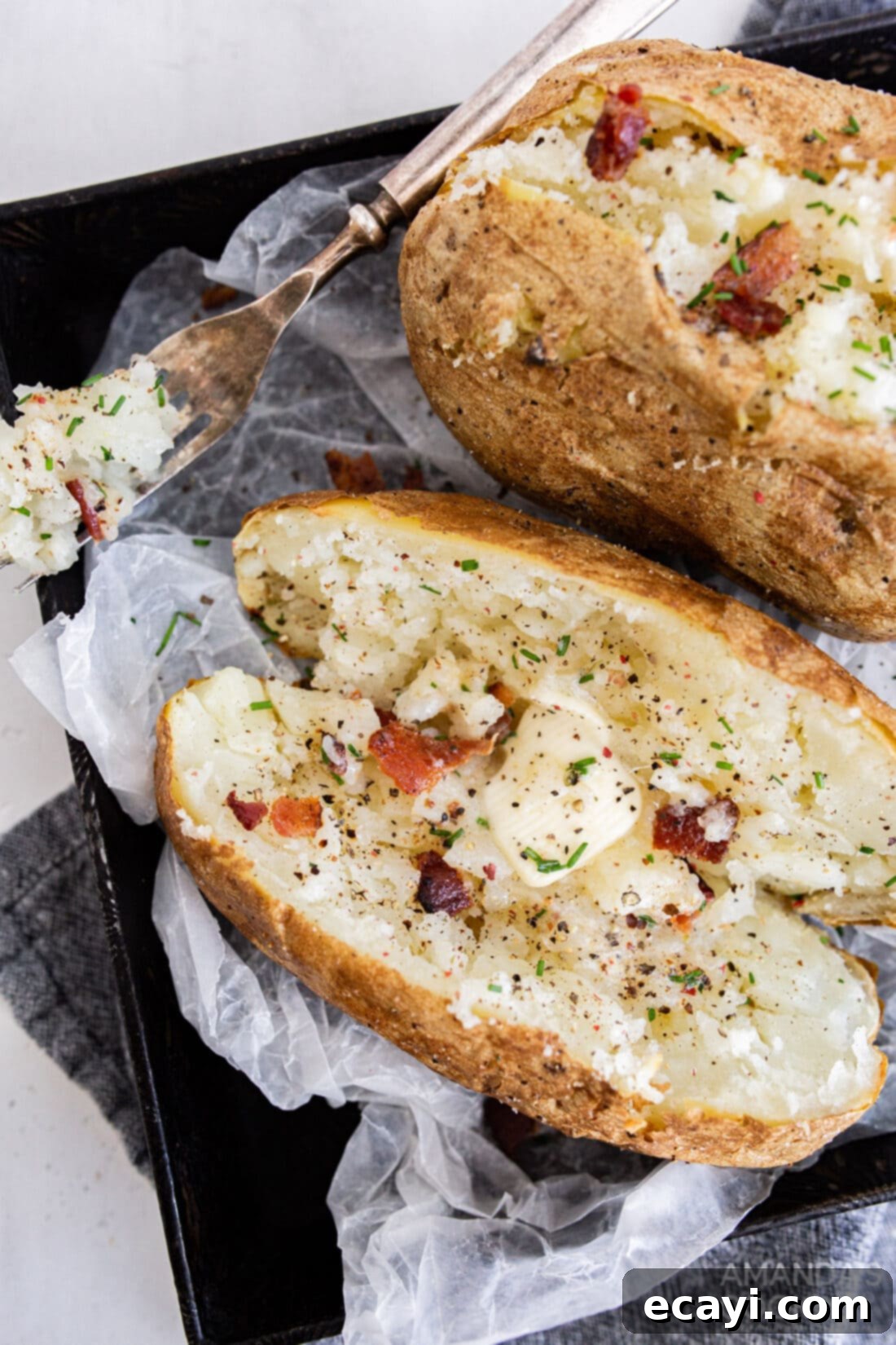 Perfect Air Fryer Baked Potatoes 2 baked potato with butter and bacon