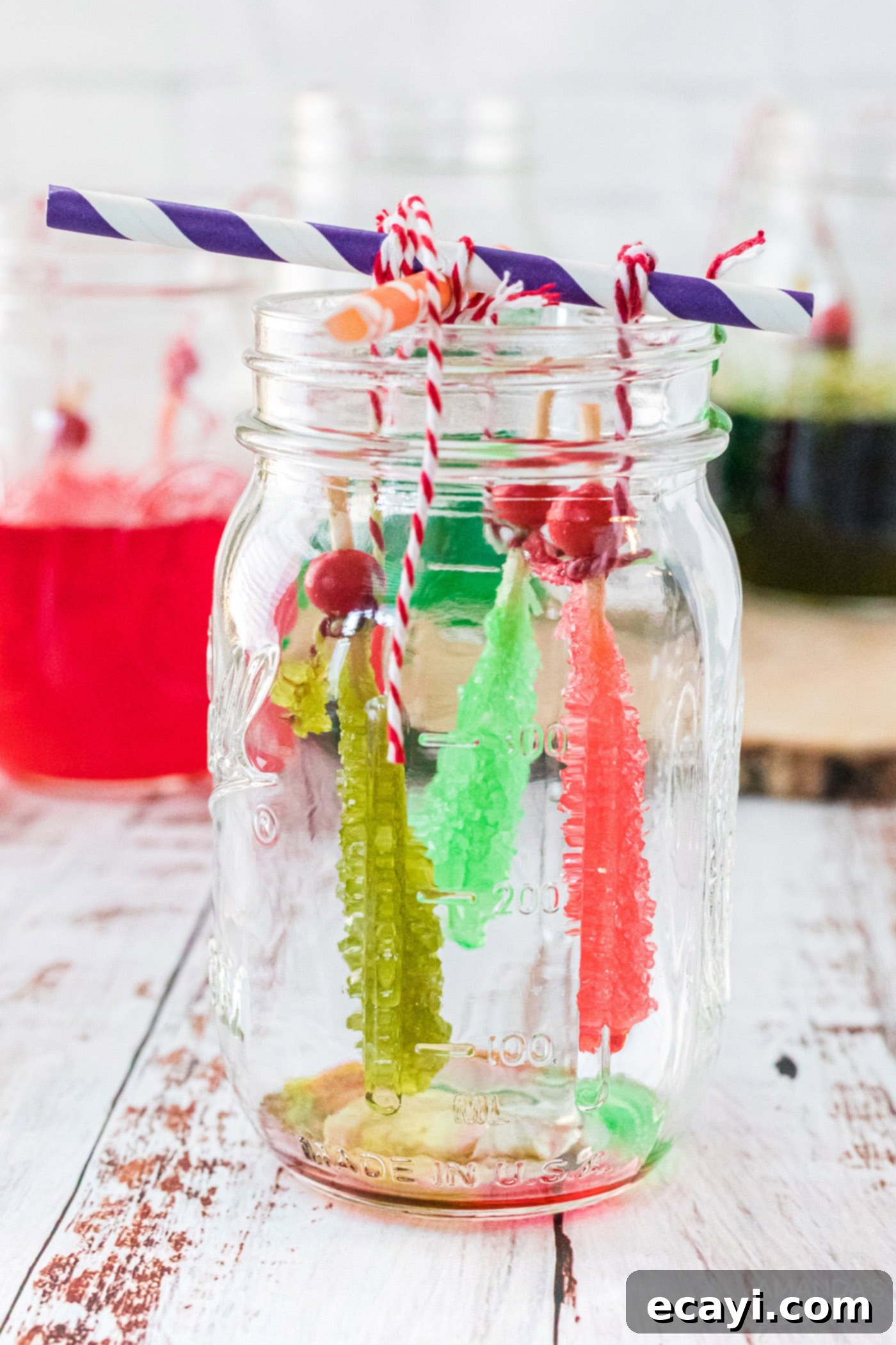 Edible Geodes 14 Finished rock candy sticks hanging to dry in a jar, ready for enjoyment