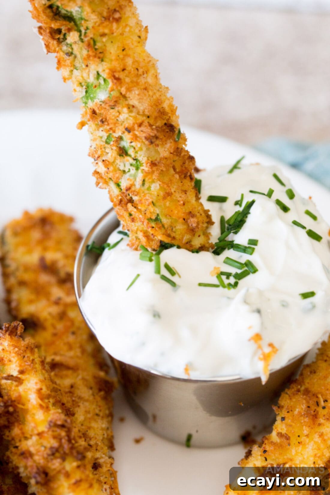 Crispy Air-Fried Zucchini Sticks 2 dipping an air fryer zucchini fry into sauce