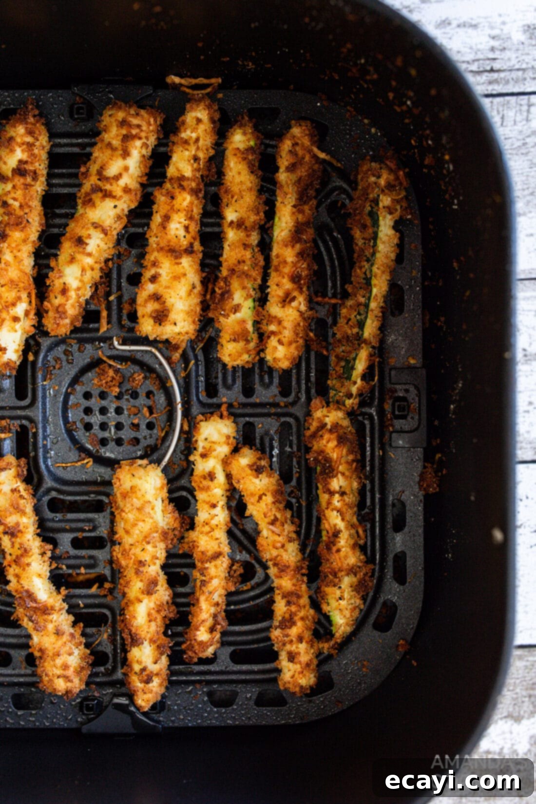 Crispy Air-Fried Zucchini Sticks 3 air fryer zucchini fries in an air fryer basket