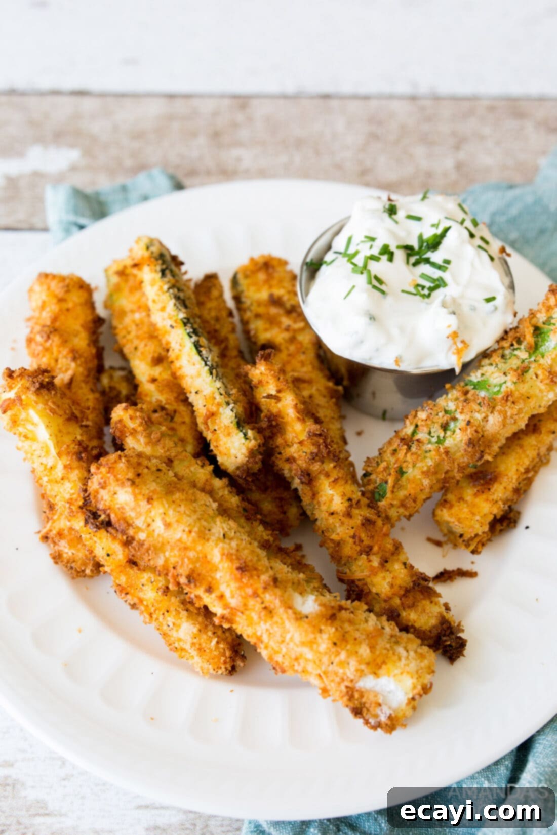 Crispy Air-Fried Zucchini Sticks 9 air fryer zucchini fries and sauce on a plate