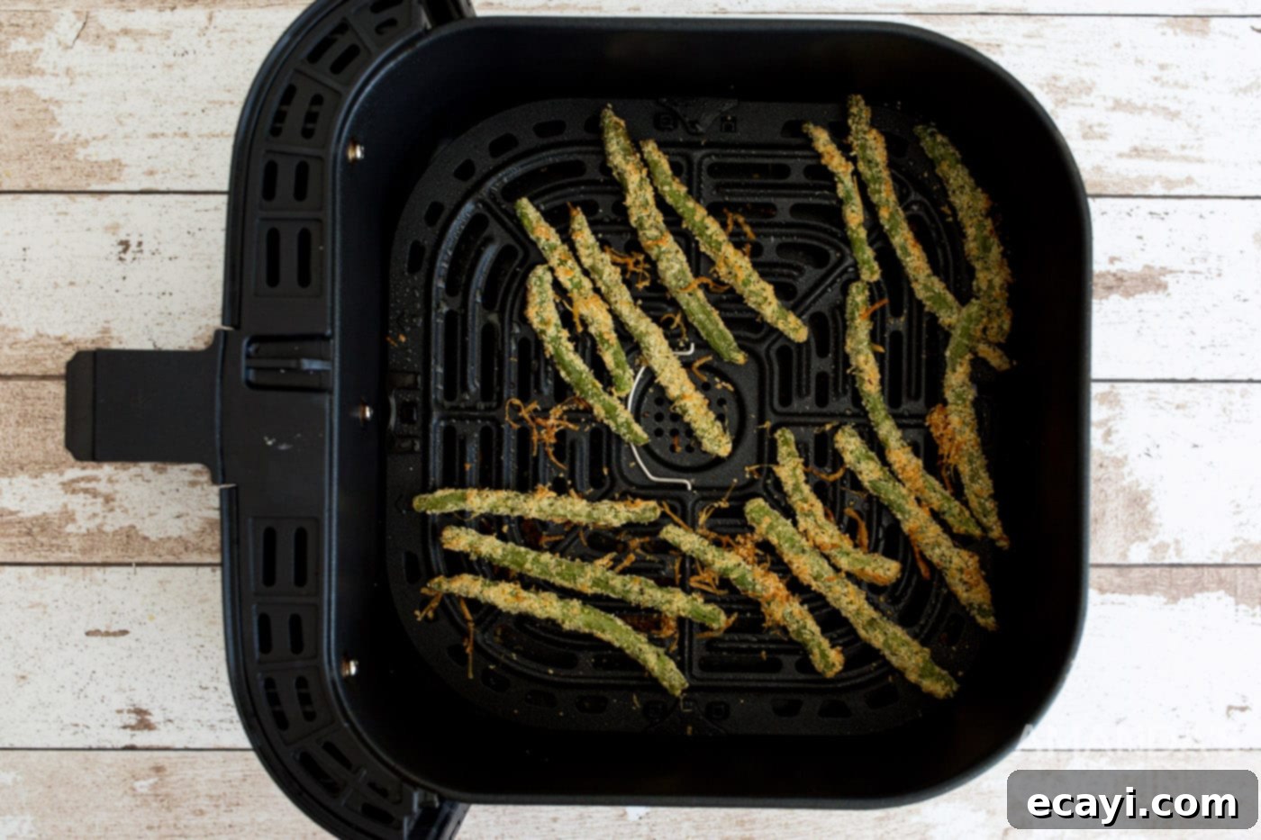 Crispy Air-Fried Green Bean Sticks 8 cooked green bean fries in air fryer basket