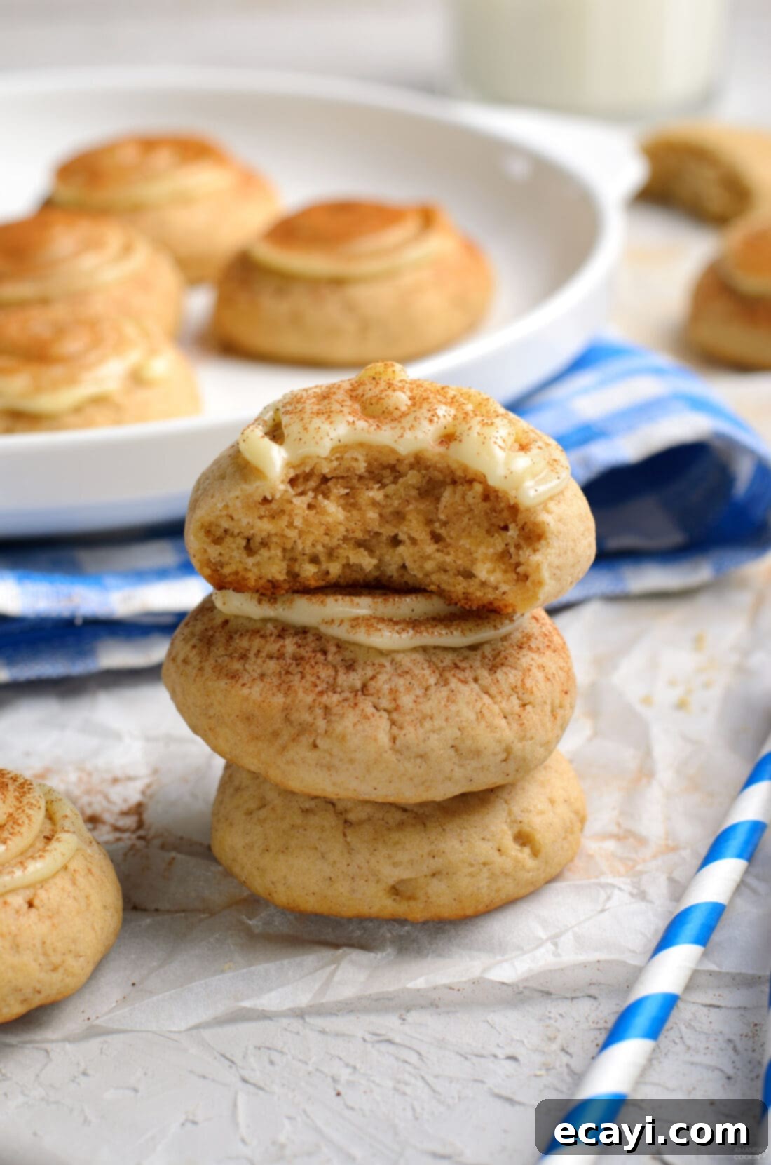 Cinnamon Swirl Delights 3 A beautiful stack of three frosted cinnamon roll cookies, showcasing their soft texture and creamy topping.