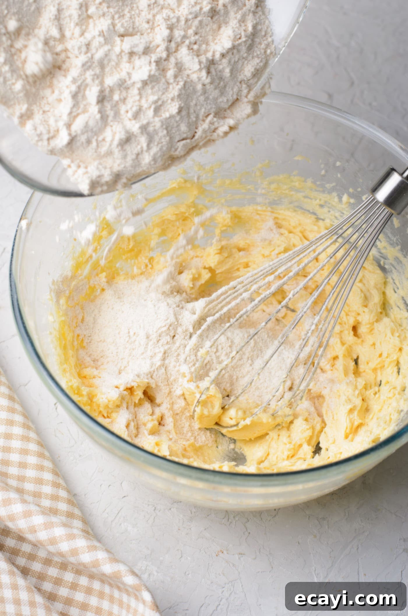 Cinnamon Swirl Delights 6 Adding dry ingredients, flour, baking powder, cinnamon, and salt, to the wet butter and sugar mixture to form the cookie dough.