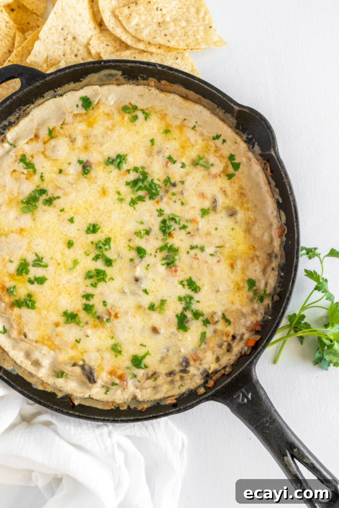 Loaded Philly Cheesesteak Dip 2 Bubbly and creamy Philly Cheesesteak Dip in a cast iron skillet, ready to serve.