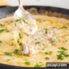 Loaded Philly Cheesesteak Dip 13 lifting Philly Cheesesteak Dip with a spoon