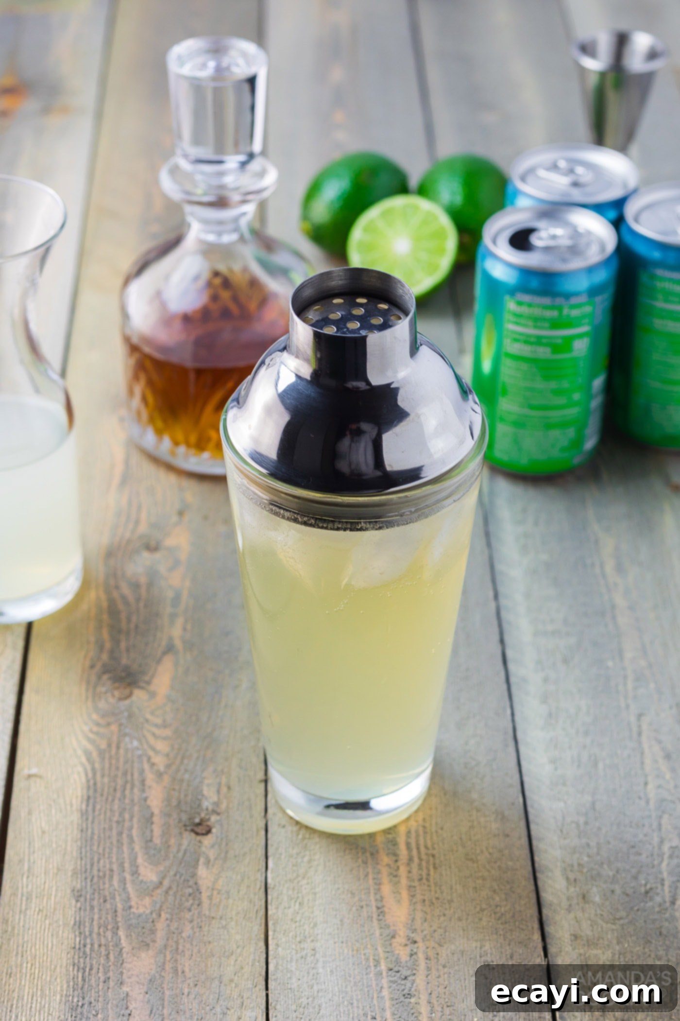 Boozy Limeade 7 spiked limeade with cocktail shaker lid on glass