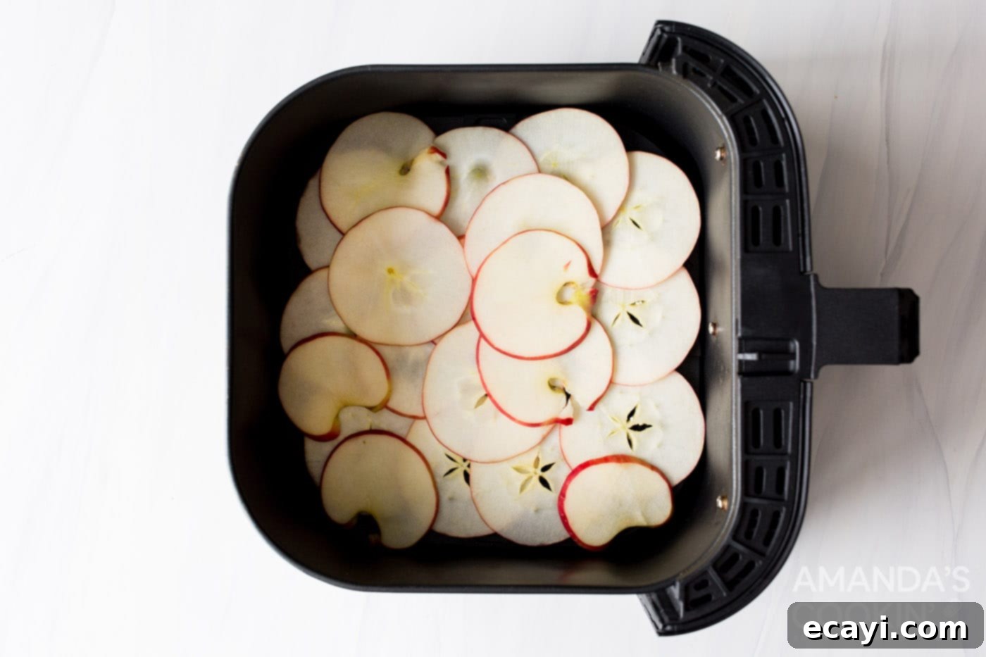Crispy Air-Fried Apple Slices 7 apple slices in an air fryer basket