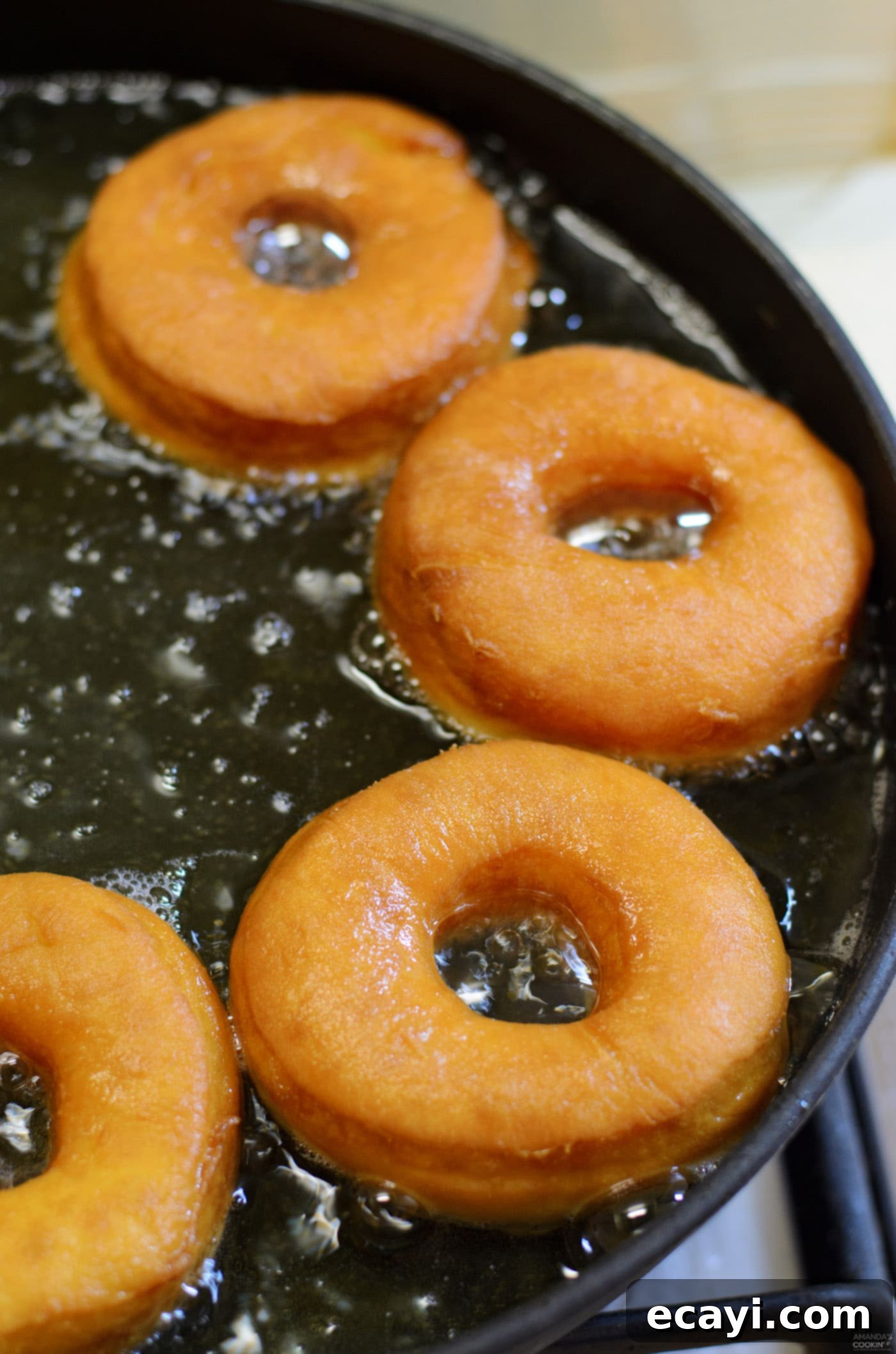Peanut Butter and Jelly Donut Perfection 11 Frying donuts in hot oil until golden brown, showing the bubbling action