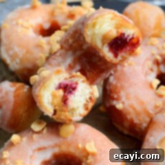 Peanut Butter and Jelly Donut Perfection 15 A delicious homemade donut cut in half, revealing the warm peanut butter and raspberry jelly filling