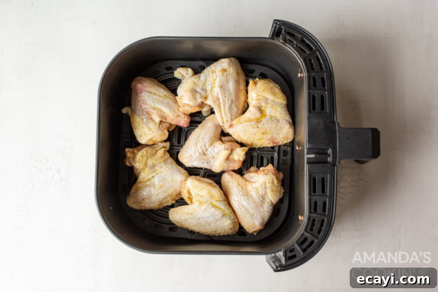 Crispy Air-Fried Wings 7 chicken wings in air fryer basket