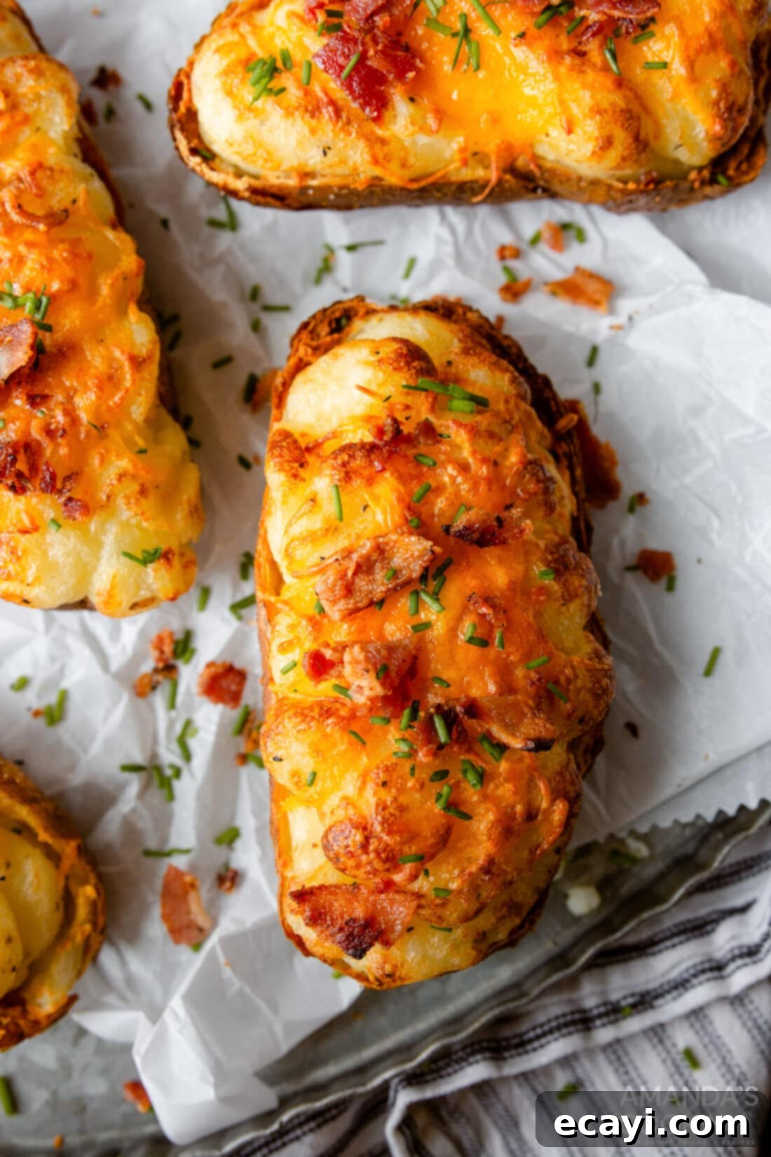 Golden Crispy Air Fryer Twice Baked Potatoes 11 A stunning close-up of Air Fryer Twice Baked Potatoes, generously topped with cheese, bacon, and chives