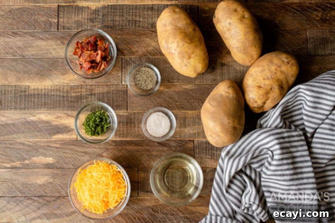 Golden Crispy Air Fryer Twice Baked Potatoes 4 Ingredients laid out for making Air Fryer Twice Baked Potatoes, including potatoes, butter, cream, and toppings