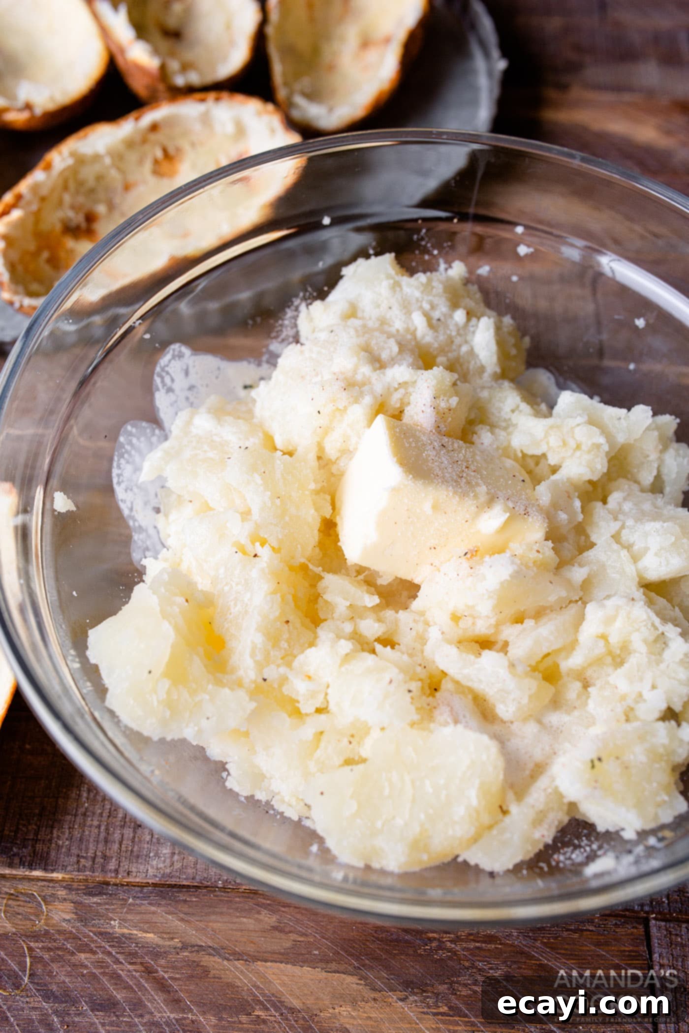 Golden Crispy Air Fryer Twice Baked Potatoes 8 Mixing bowl with scooped potato flesh, butter, and heavy whipping cream, being whipped to a creamy texture
