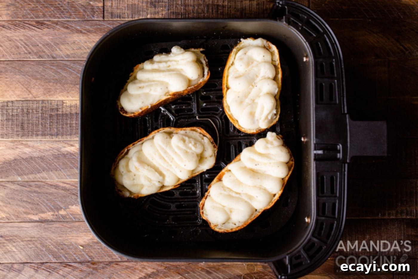 Golden Crispy Air Fryer Twice Baked Potatoes 9 Whipped and stuffed potato halves arranged in an air fryer basket, ready for the final bake