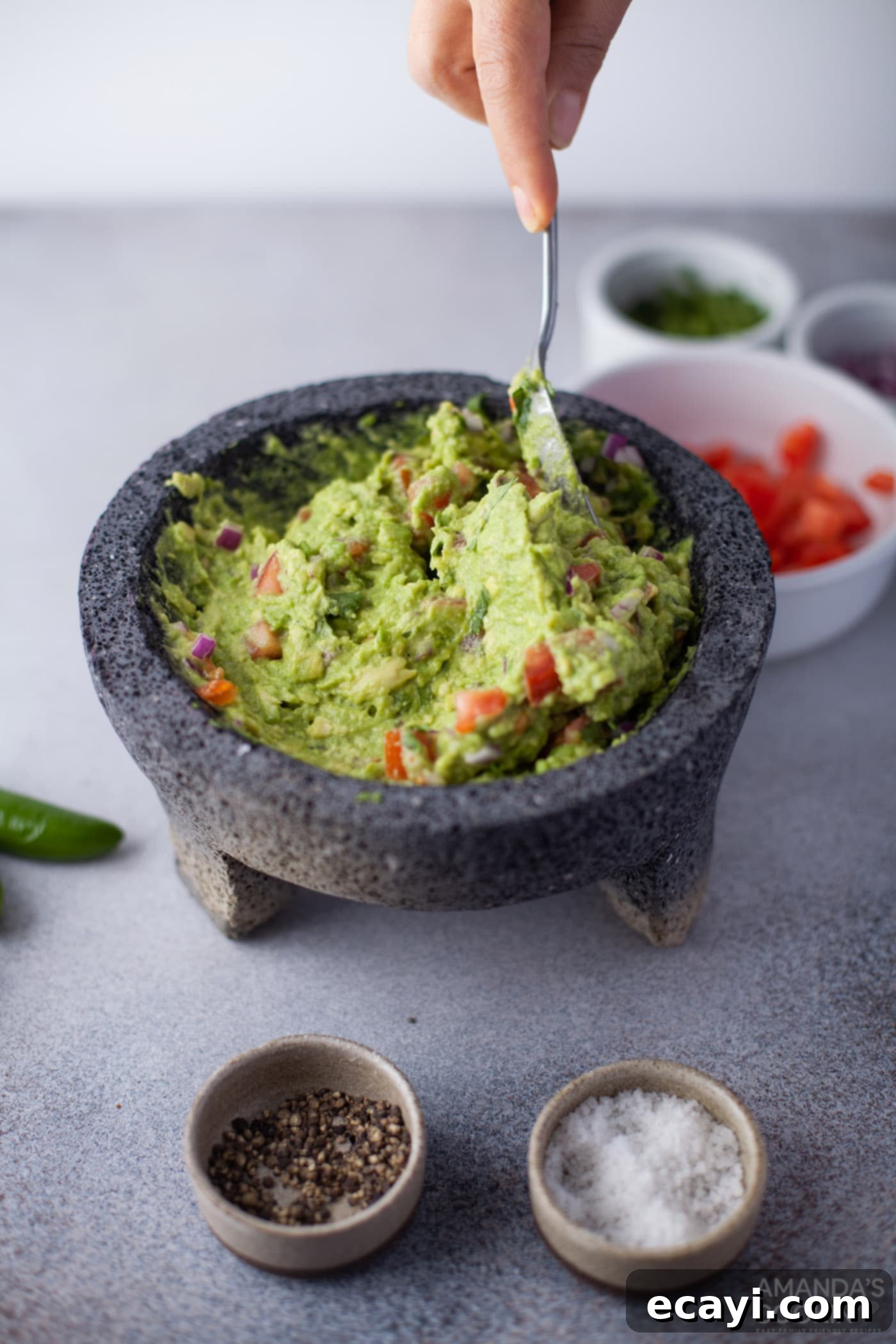 Guacamole 8 mixing guacamole with a spoon