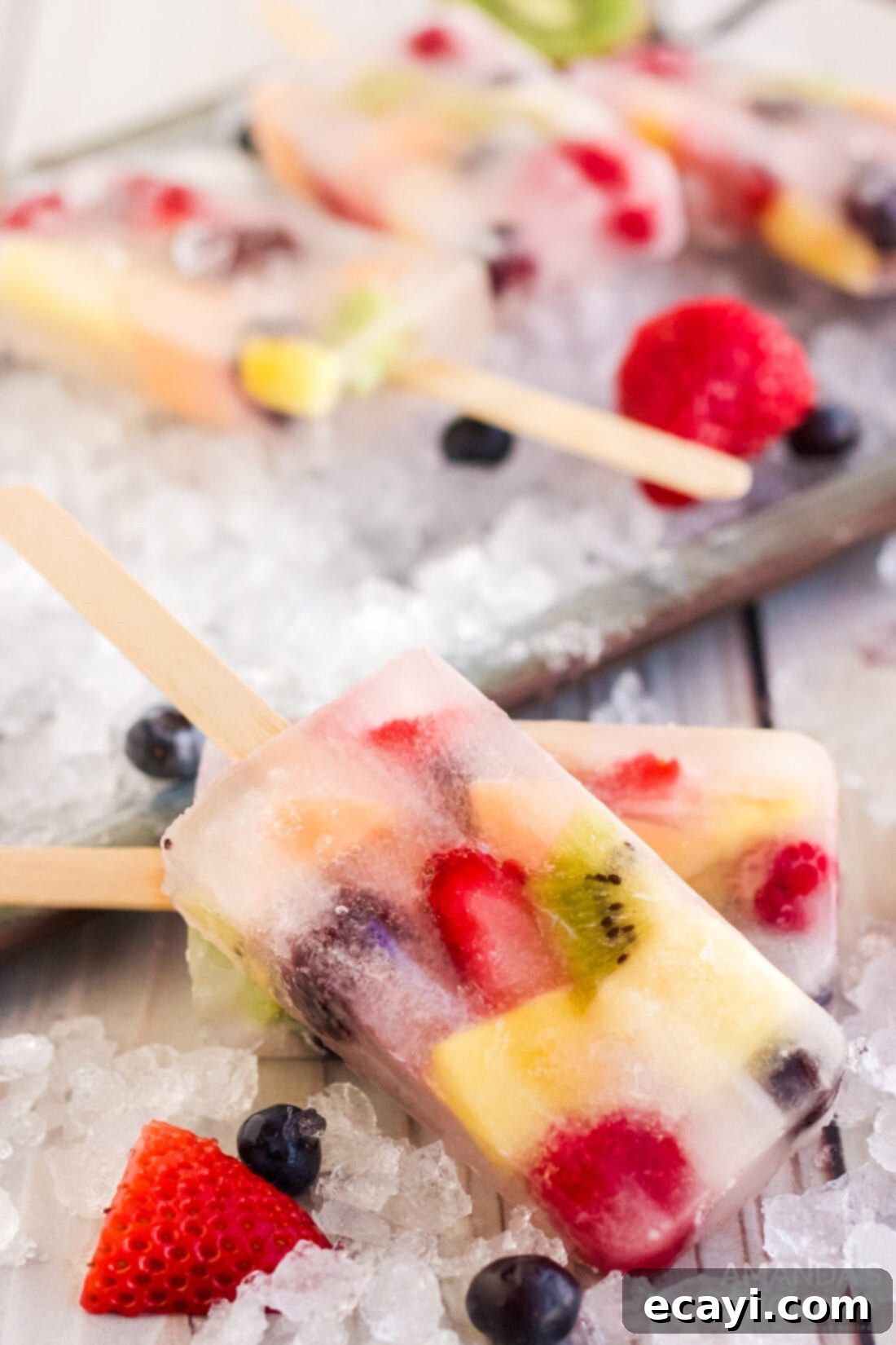 Refreshing Fruit Treats 8 A collection of perfectly frozen, colorful fruit popsicles freshly removed from molds, showcasing different fruit combinations.