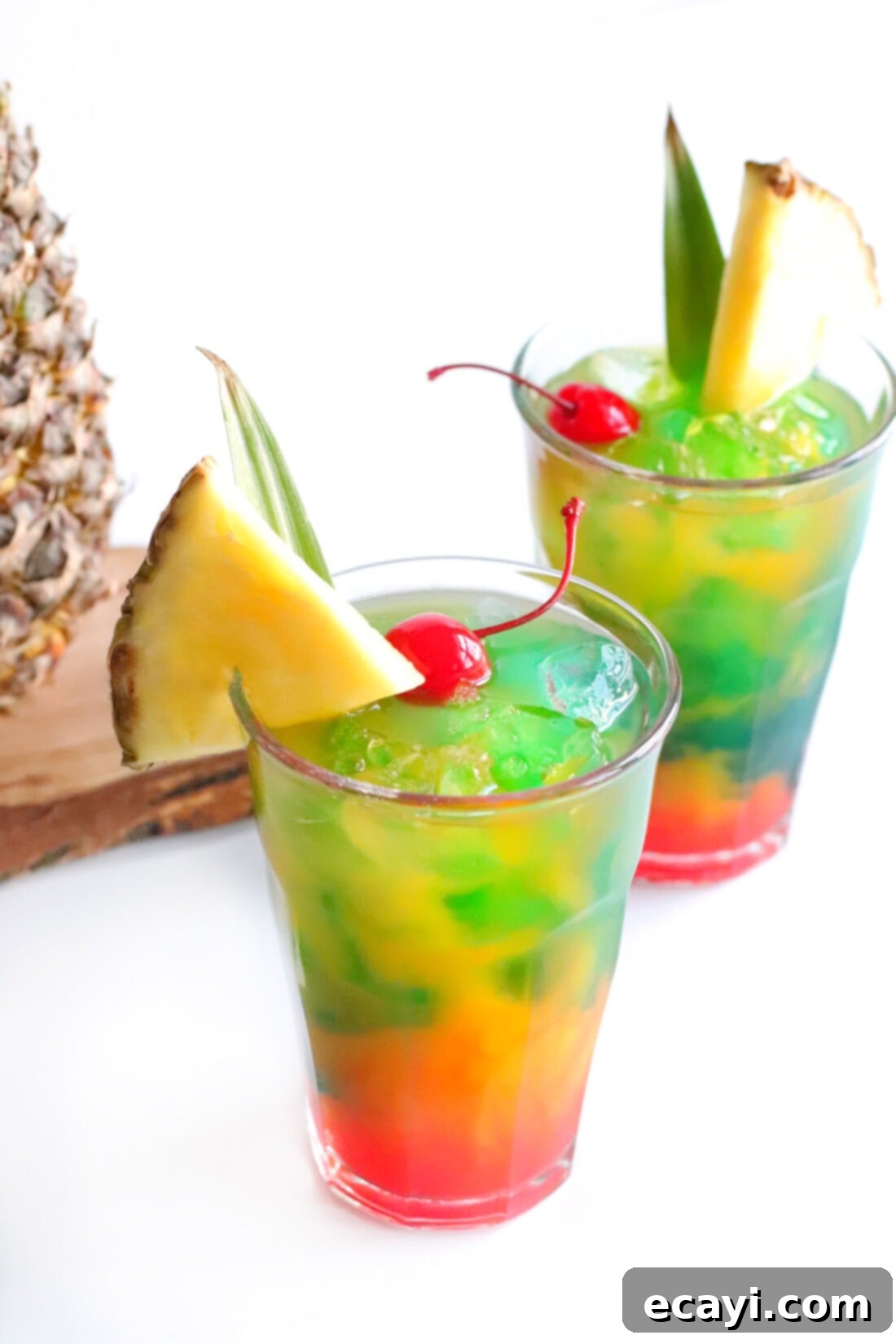 Azure Aloha Mai 10 Two vibrant Blue Hawaiian Mai Tai drinks, beautifully garnished with pineapple wedges and cherries, ready for a tropical celebration.