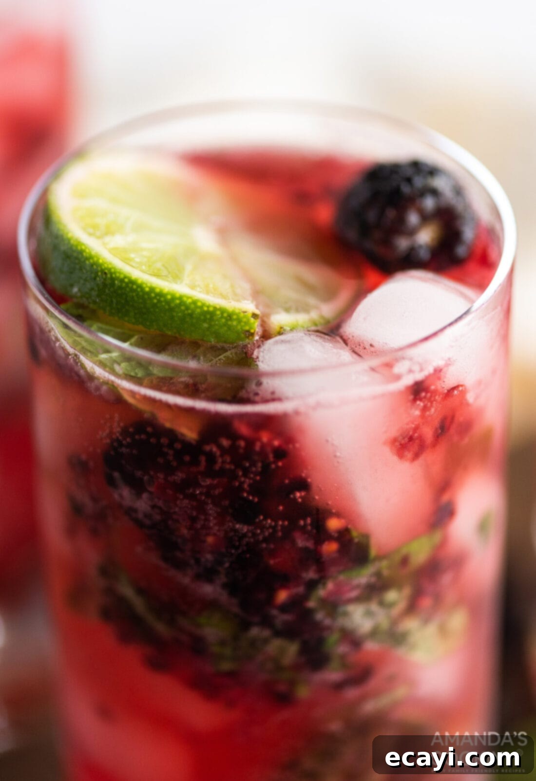 Midnight Berry Mojito 3 Close-up of a single Blackberry Mojito glass, showcasing muddled berries, mint, and ice, ready to be enjoyed