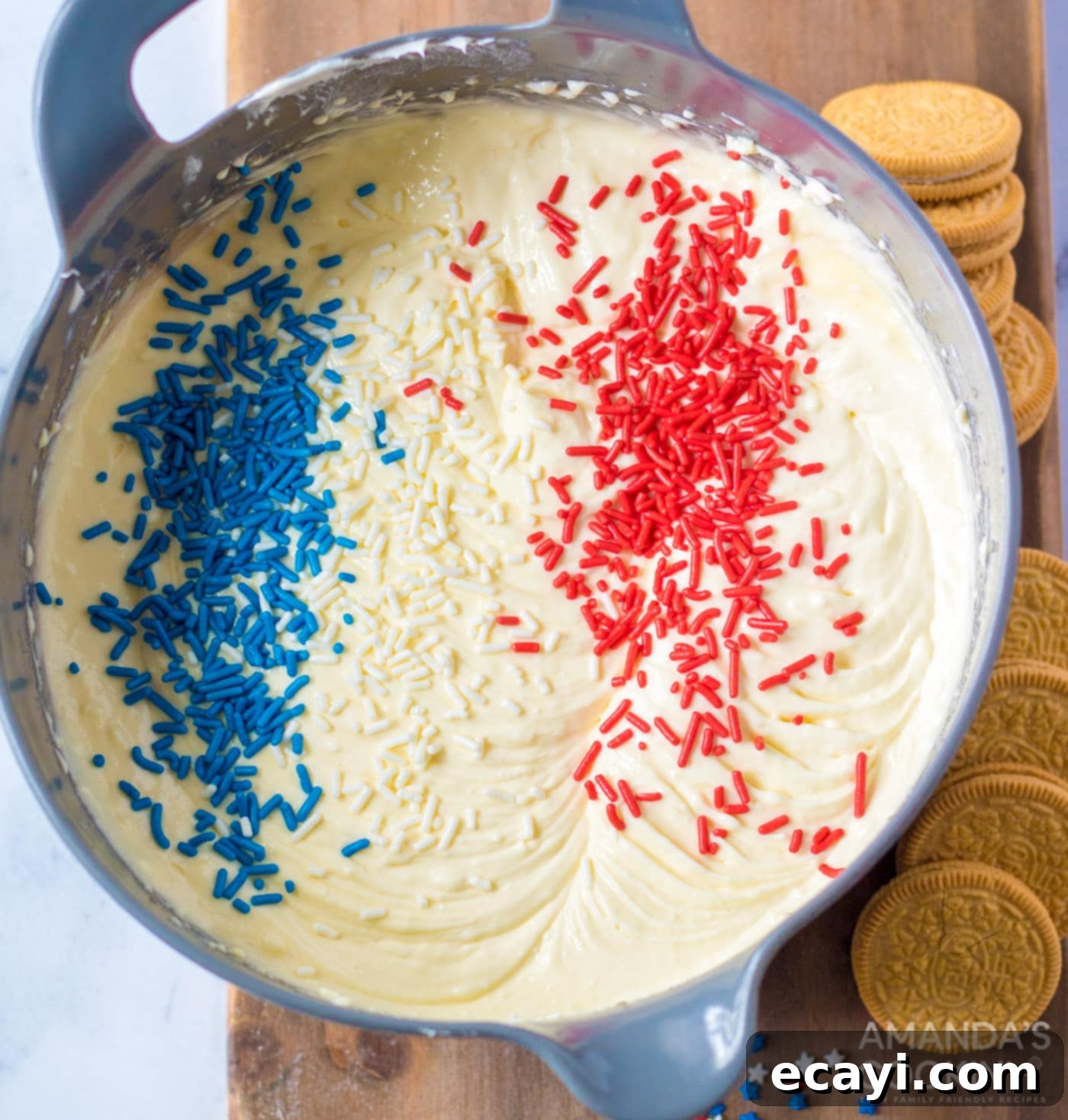 Stars and Stripes Cheesecake Bites 5 red white and blue sprinkles on cheesecake batter, showing the gentle folding process