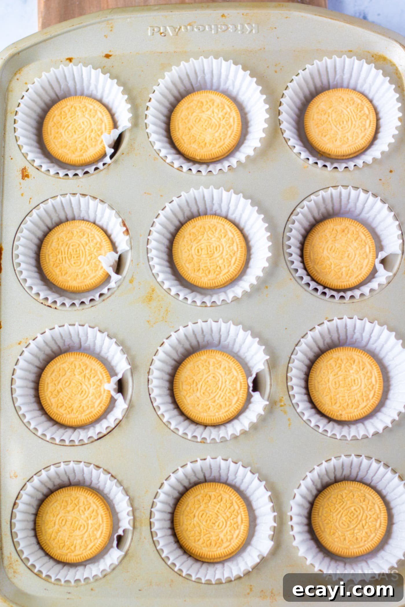 Stars and Stripes Cheesecake Bites 6 golden Oreos in a mini muffin tin, ready for the cheesecake batter