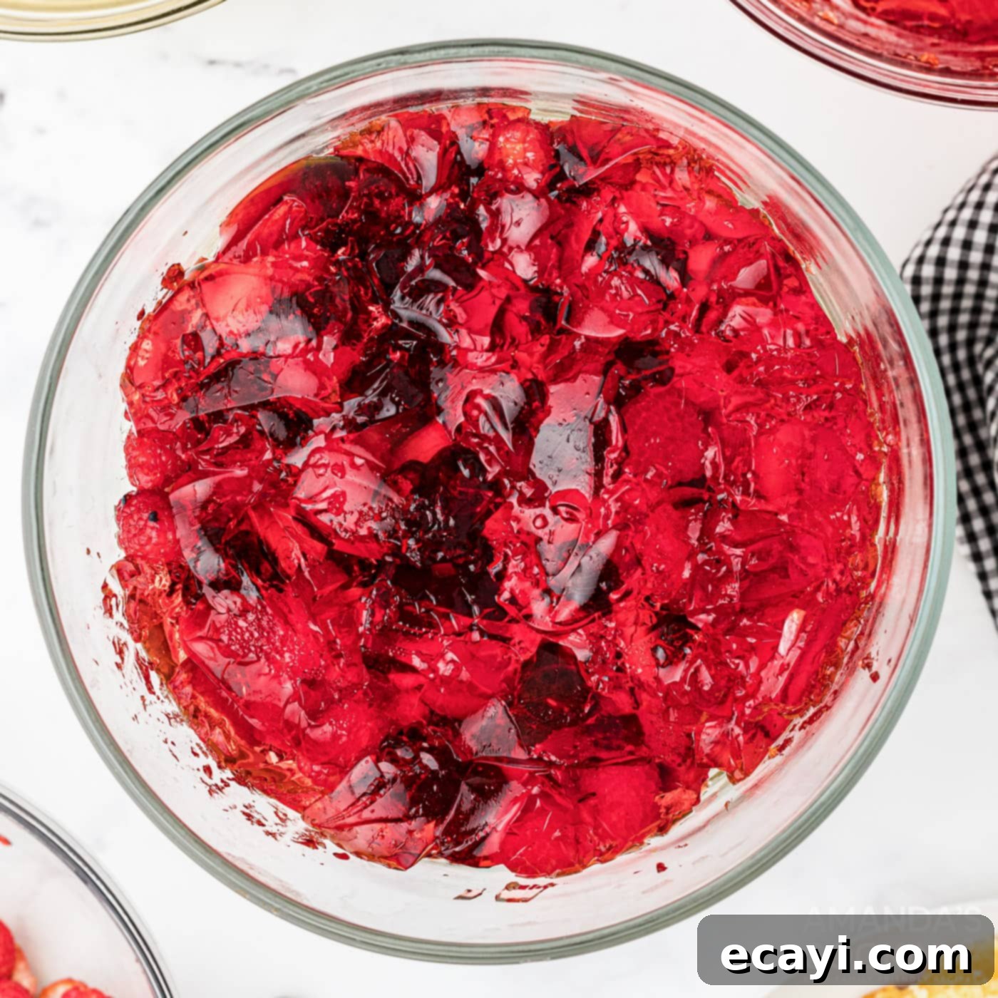 Whimsical Jelly Parfait 9 set jello layered on top of fruit in a clear trifle bowl