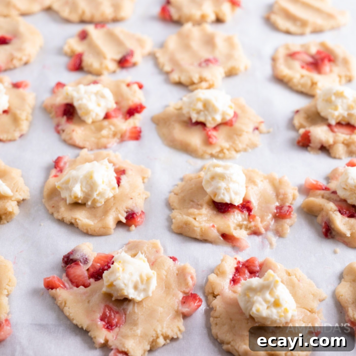 Zesty Strawberry Lemonade Cookies 12 Cream cheese balls carefully placed on top of flattened cookie dough circles.
