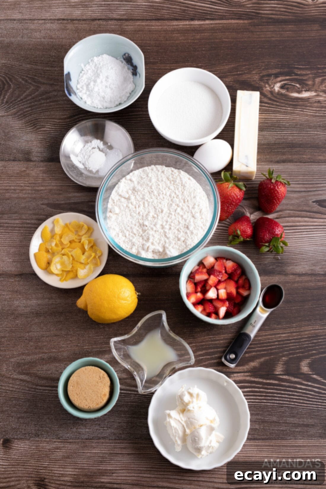 Zesty Strawberry Lemonade Cookies 4 Close-up view of fresh ingredients for strawberry lemonade cookies, including strawberries, lemons, butter, flour, and cream cheese.