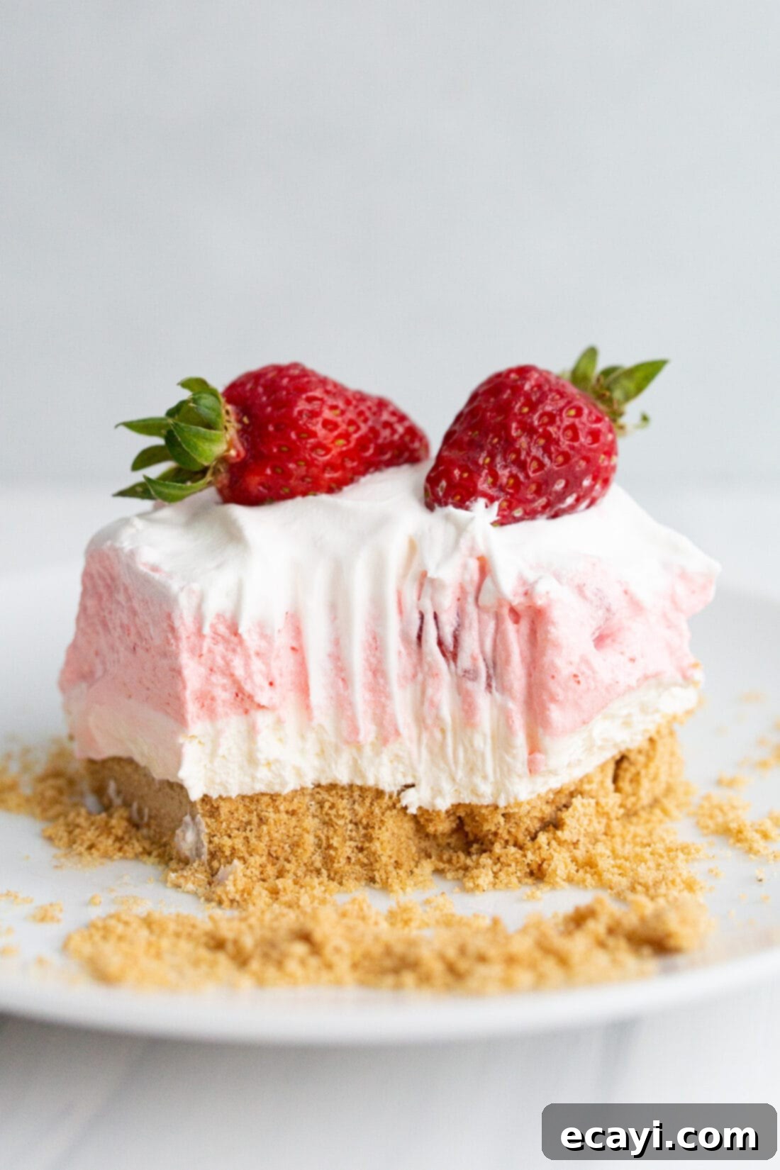Strawberry Dream Layers 2 Square of Strawberry Lasagna on a plate with a bite taken out