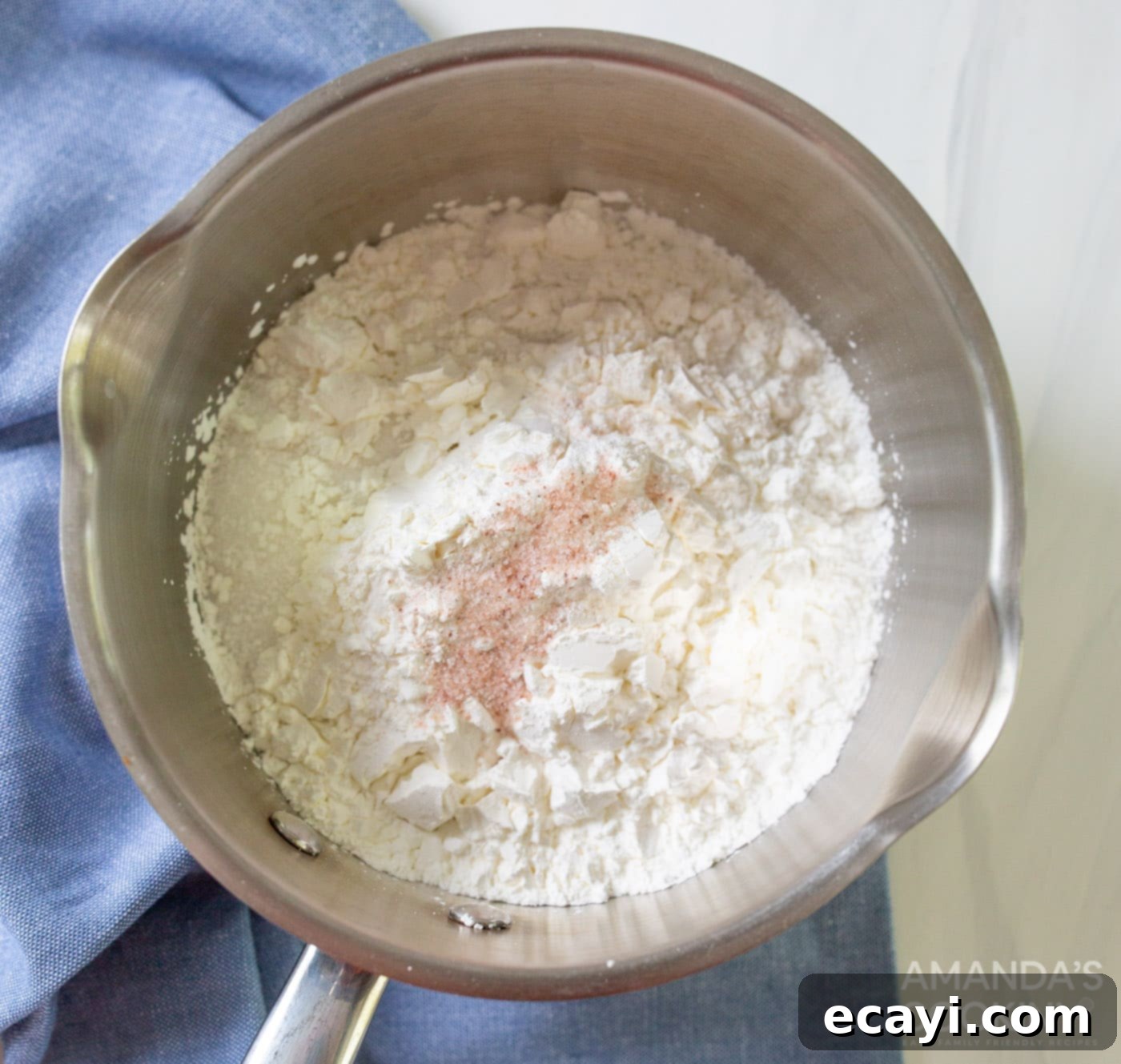 Lemon Meringue Pie 5 Granulated sugar, salt, and cornstarch mixed in a saucepan with water, being whisked.