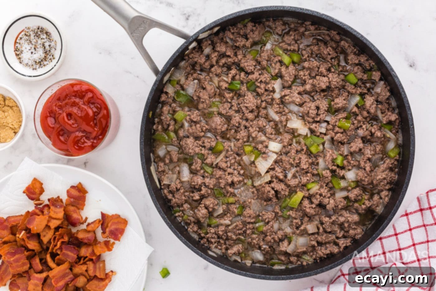 Smoky Bacon Sloppy Joes 6 Ground beef, onions, and bell peppers cooking in a skillet
