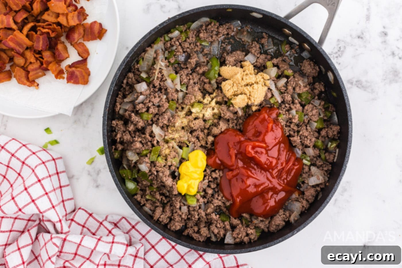 Smoky Bacon Sloppy Joes 7 Ketchup, mustard, and other sauce ingredients added to the ground beef in the pan