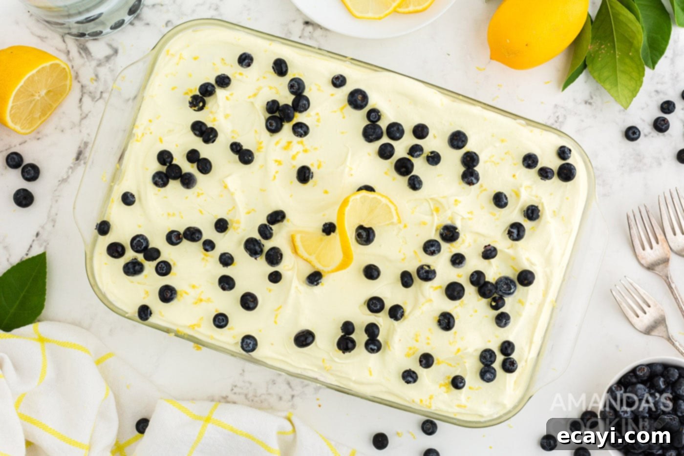 Zesty Lemon Blueberry Cloud Cake 12 Overhead shot of a garnished Lemon Blueberry Icebox Cake with fresh blueberries and lemon zest, ready to serve.