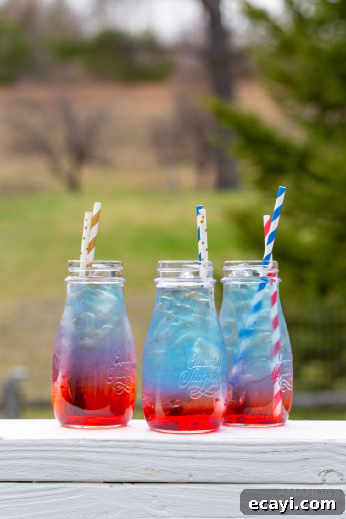 Patriot's Zeal 3 Close-up of multiple mason jars showcasing the vibrant, distinct red, white, and blue layers of the patriotic punch.