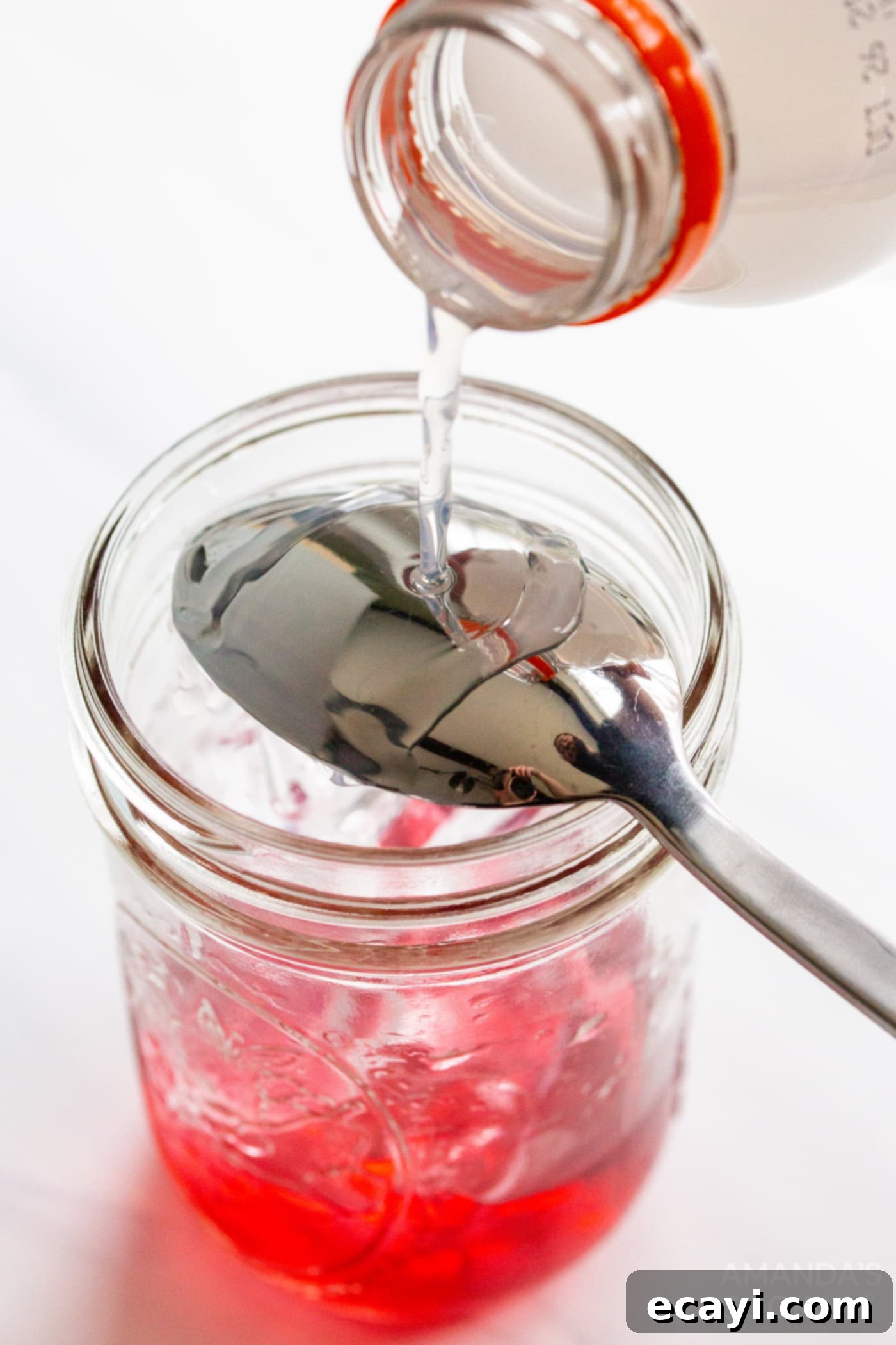 Patriot's Zeal 6 Pouring the white Gatorade Frost layer carefully over an upside-down spoon into a mason jar with the red juice and ice.