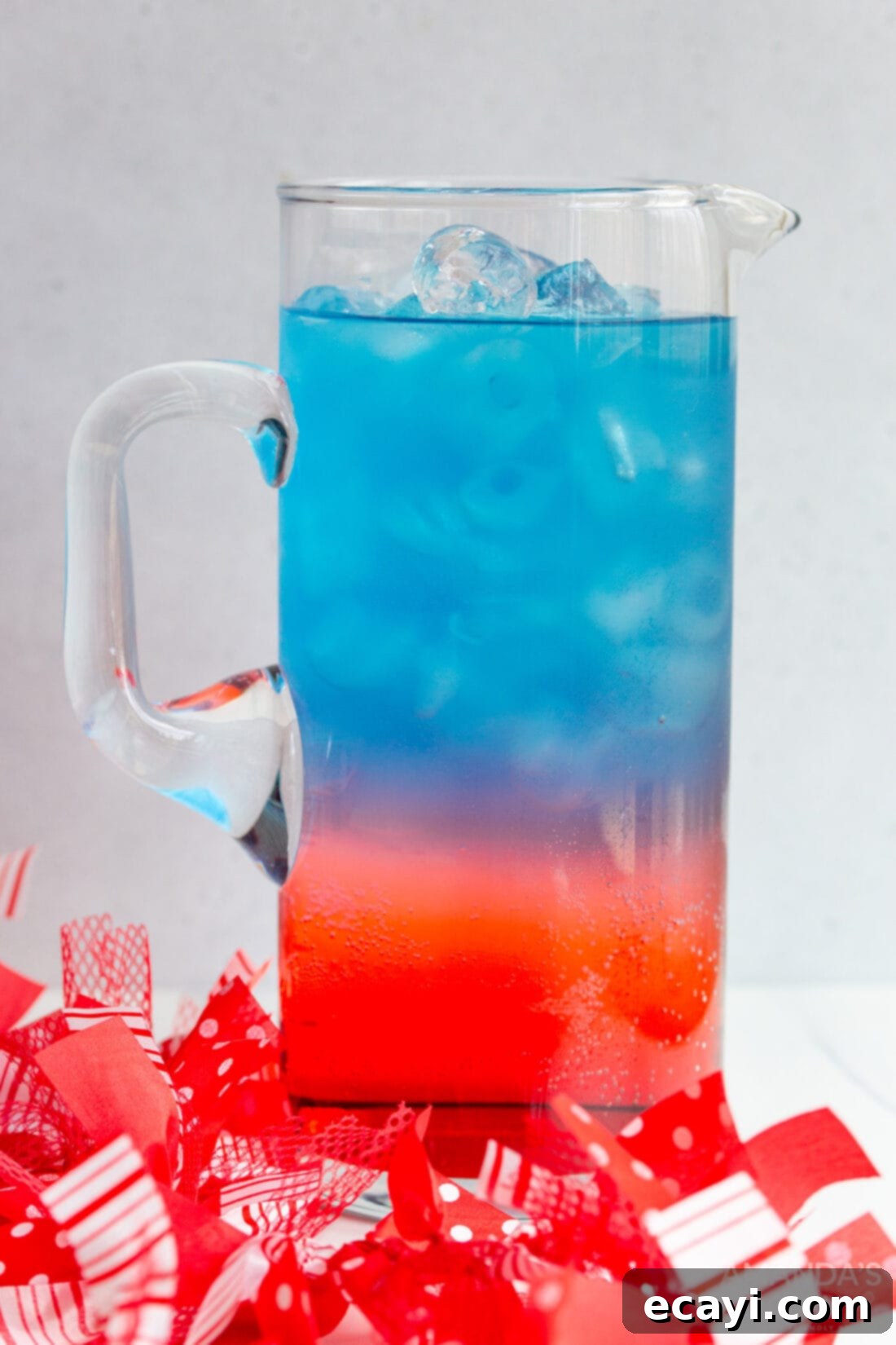 Patriot's Zeal 8 A large pitcher of patriotic punch, showing the layers slightly blended into a beautiful purple and blue gradient, next to a layered individual serving.